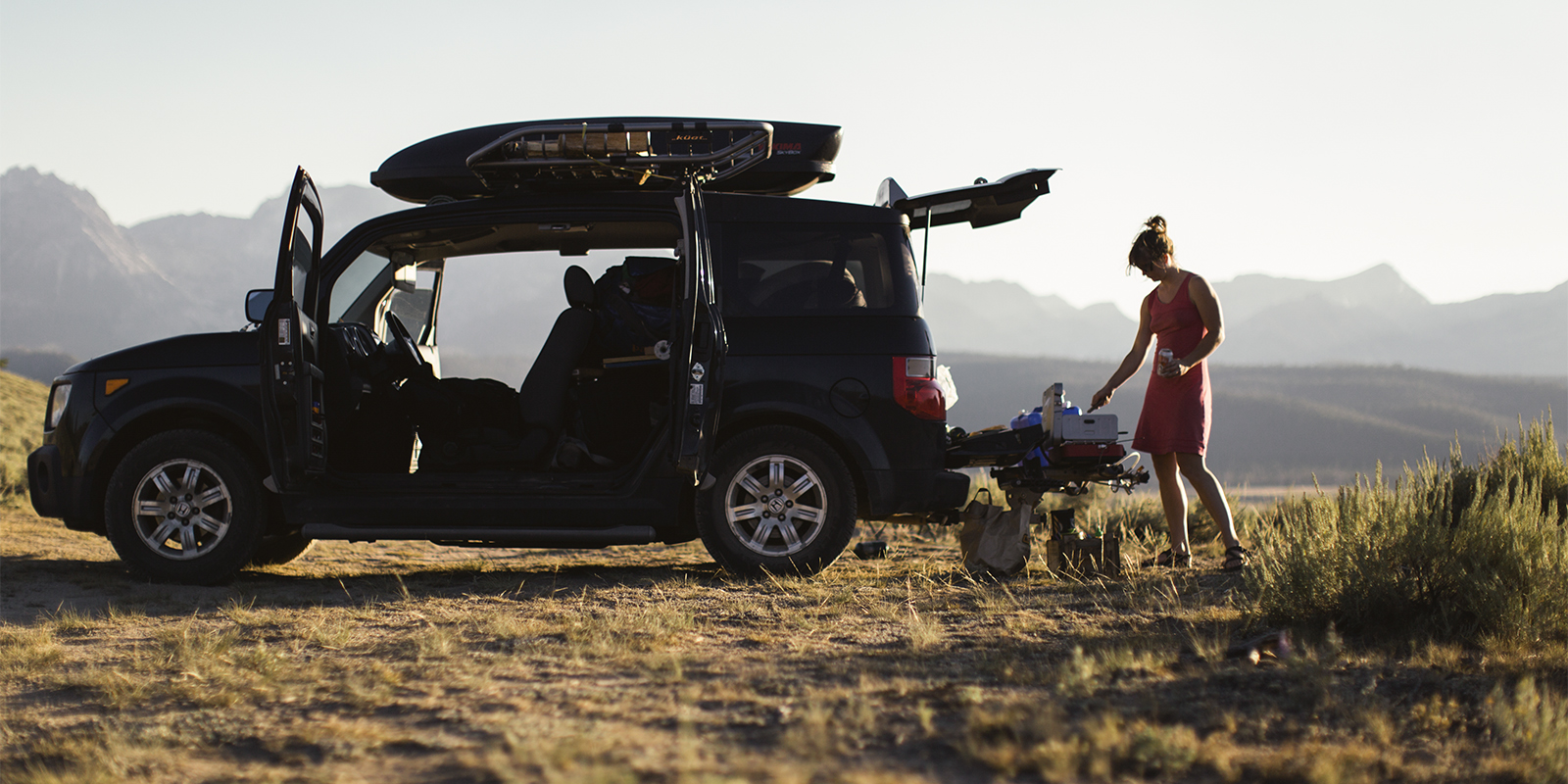 woman grilling from the trunk of her car